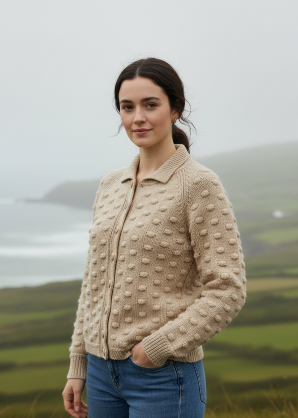 Woman wearing a beige knitted cardigan with a scenic background