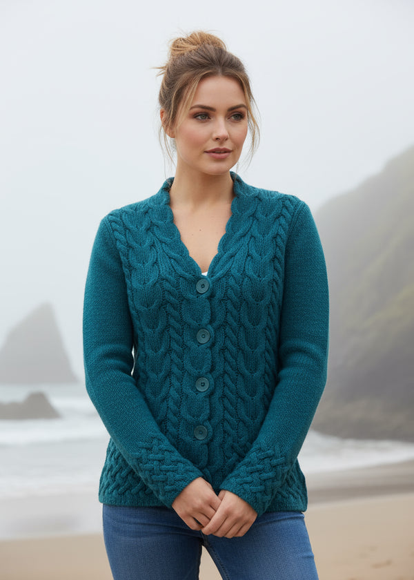 Woman wearing a teal knitted cardigan on a white background