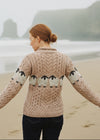 Woman wearing a knitted sweater with sheep pattern on a beach