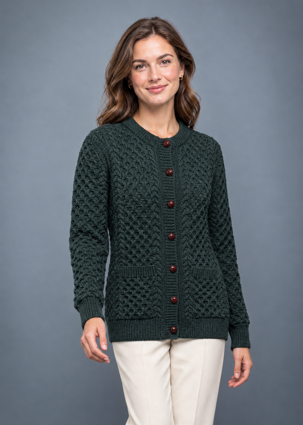 Army-green cardigan, relaxed walking studio pose