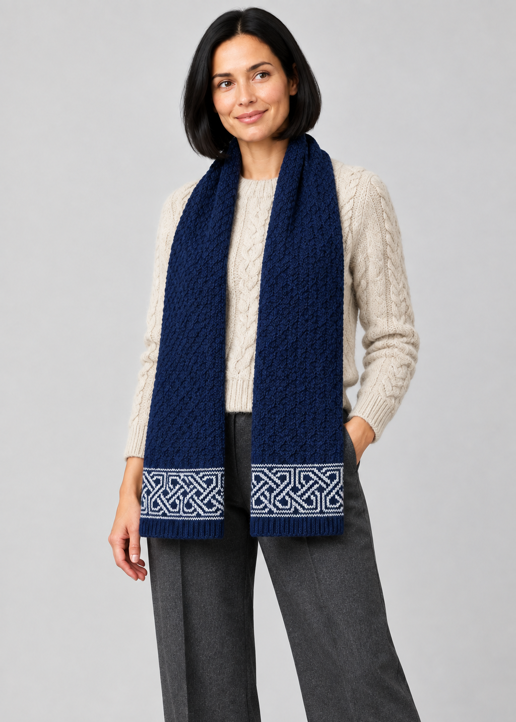 Celtic scarf over Aran knitwear, angled pose