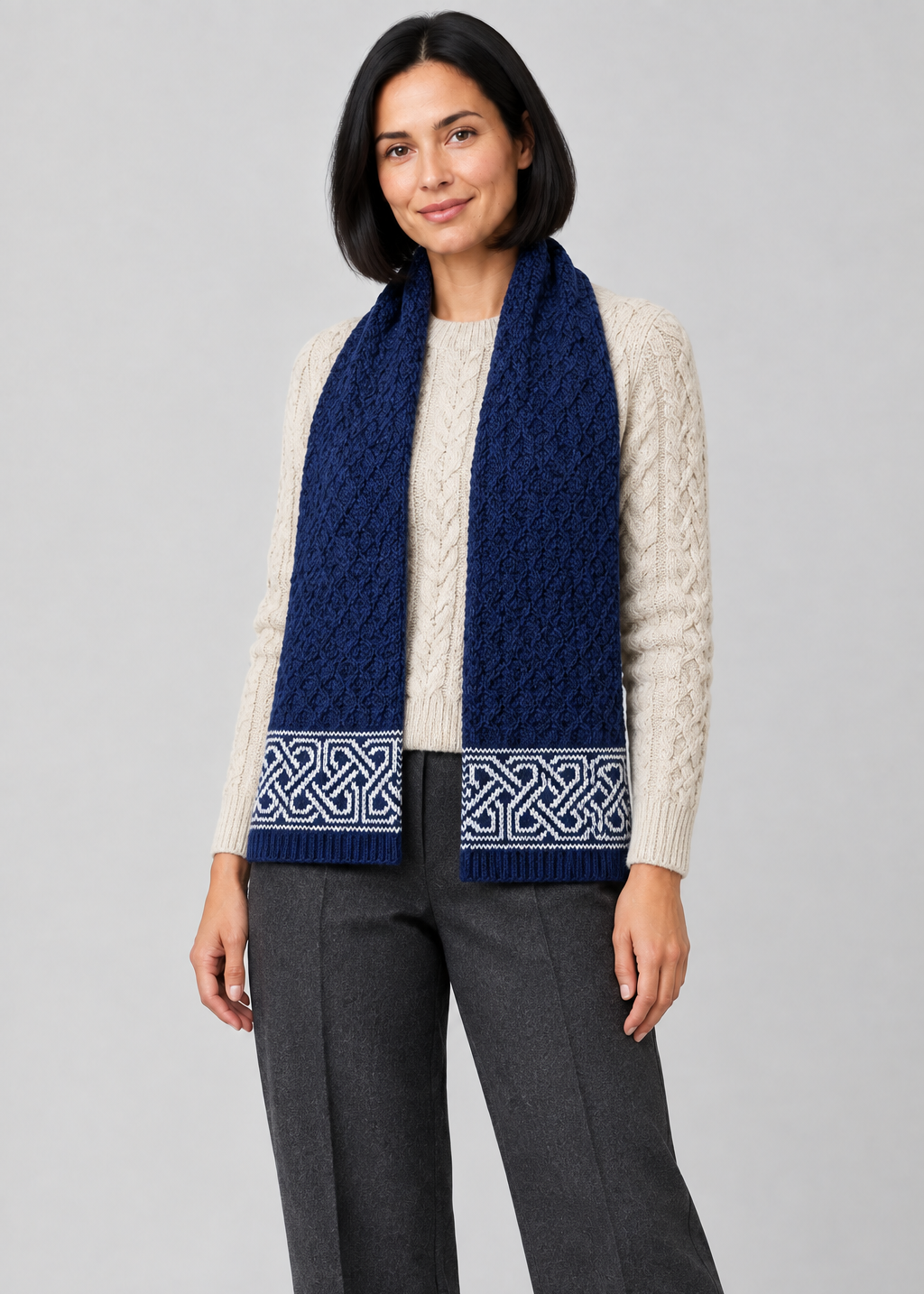 Celtic scarf over Aran knitwear, standing pose