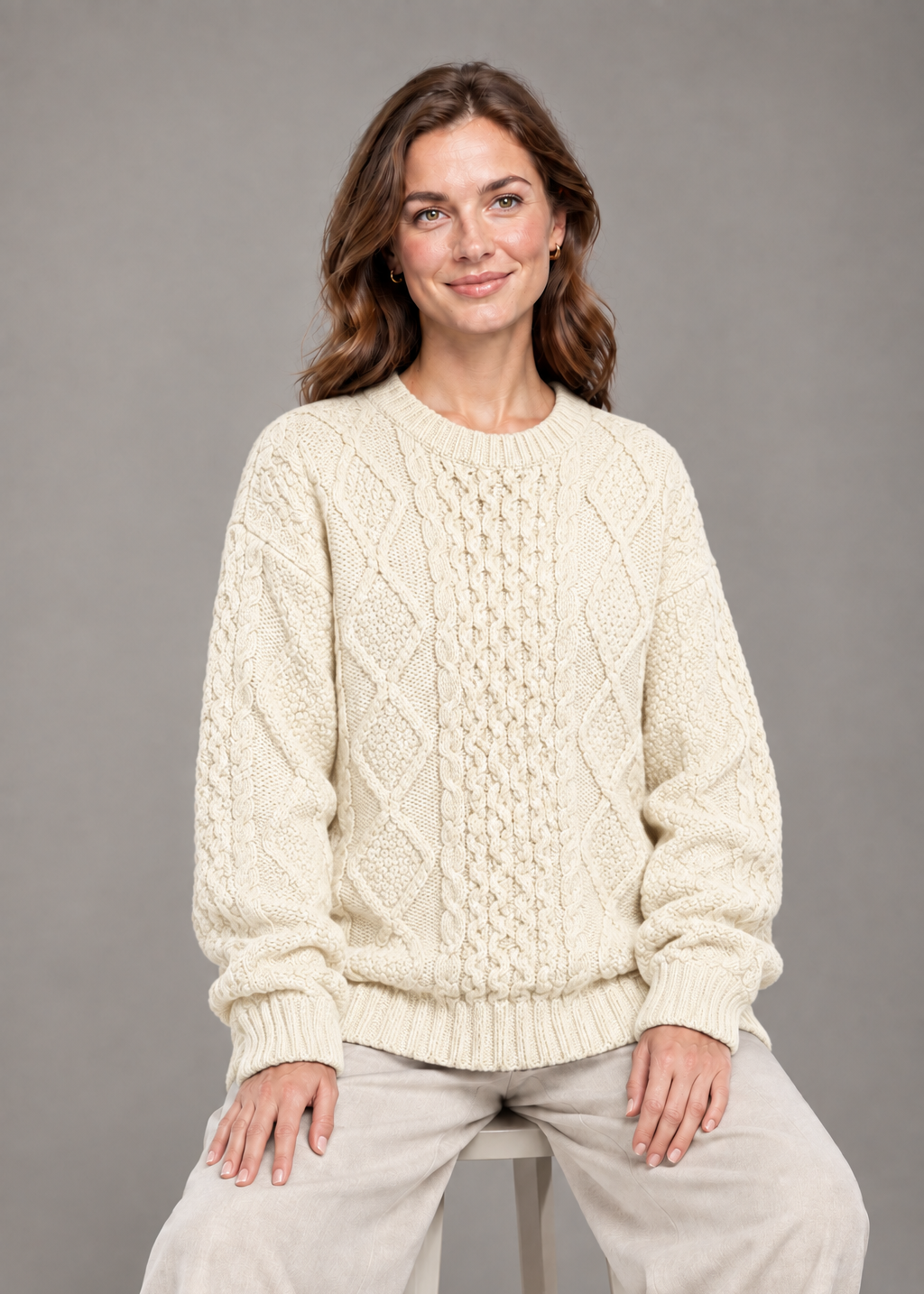 Cream oversized sweater, seated studio pose