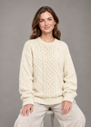 Cream oversized sweater, seated studio pose