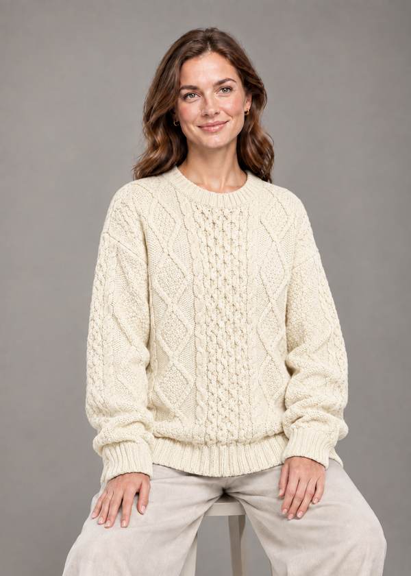 Cream oversized sweater, seated studio pose
