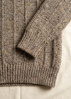 Cuff and hem close-up on off-white