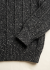 Cuff and hem close-up on off-white