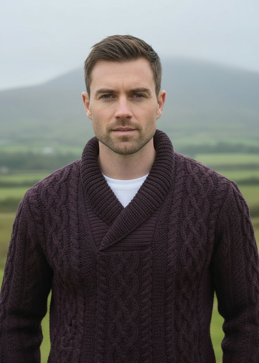 Man wearing a dark purple knitted cardigan in a scenic outdoor setting