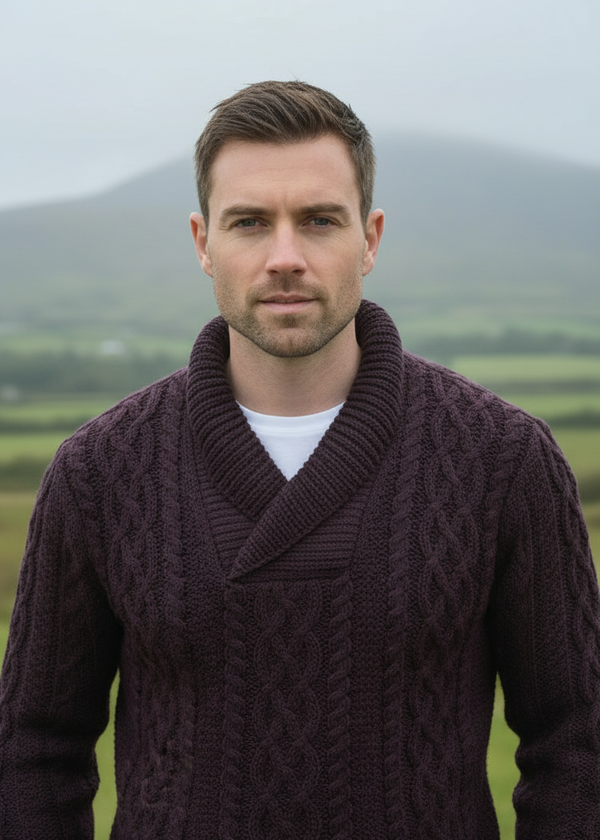 Man wearing a dark purple knitted cardigan in a scenic outdoor setting