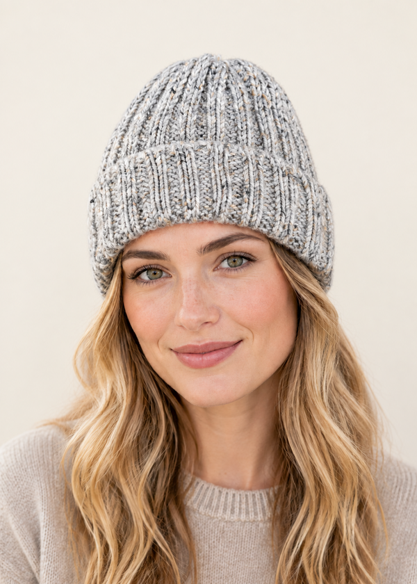 Female model wearing the grey hat on an off-white backdrop