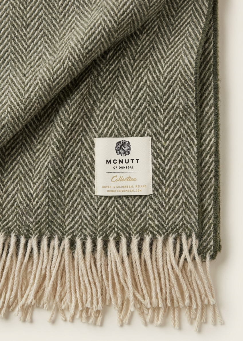 Green herringbone blanket label and fringe detail