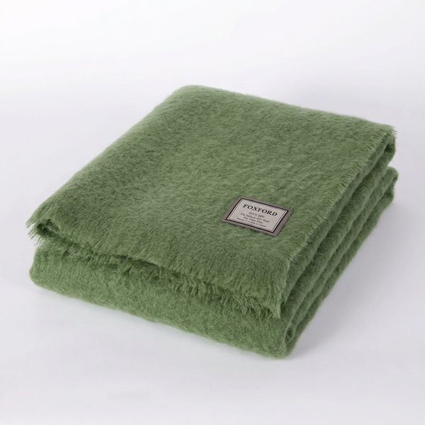 Foxford Dunloe sage green mohair throw folded on a white background