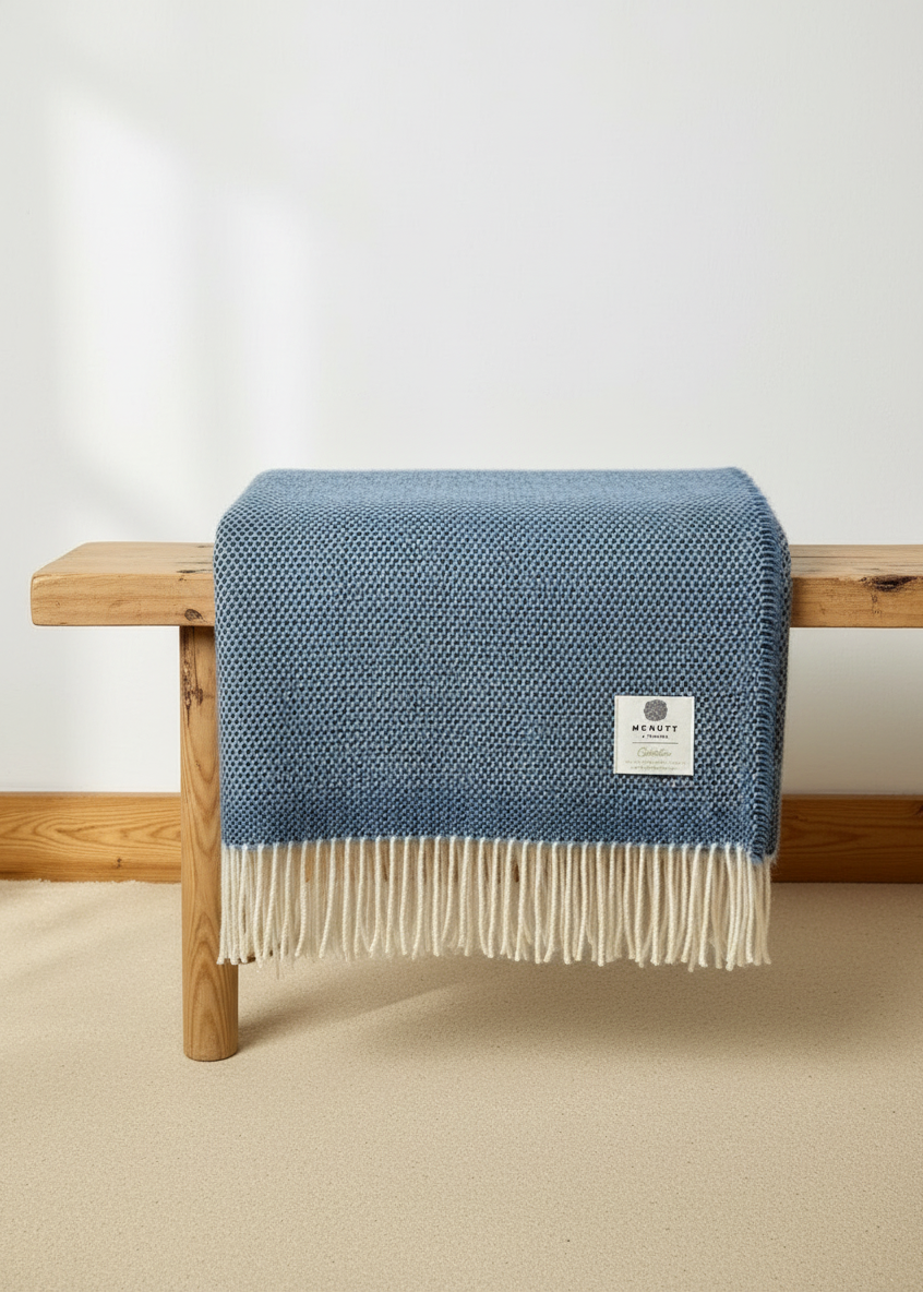 McNutt Sea Sky Blanket on rustic bench