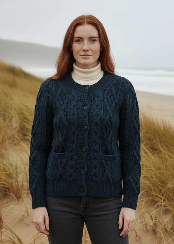 Woman wearing a dark blue knitted cardigan in a coastal setting