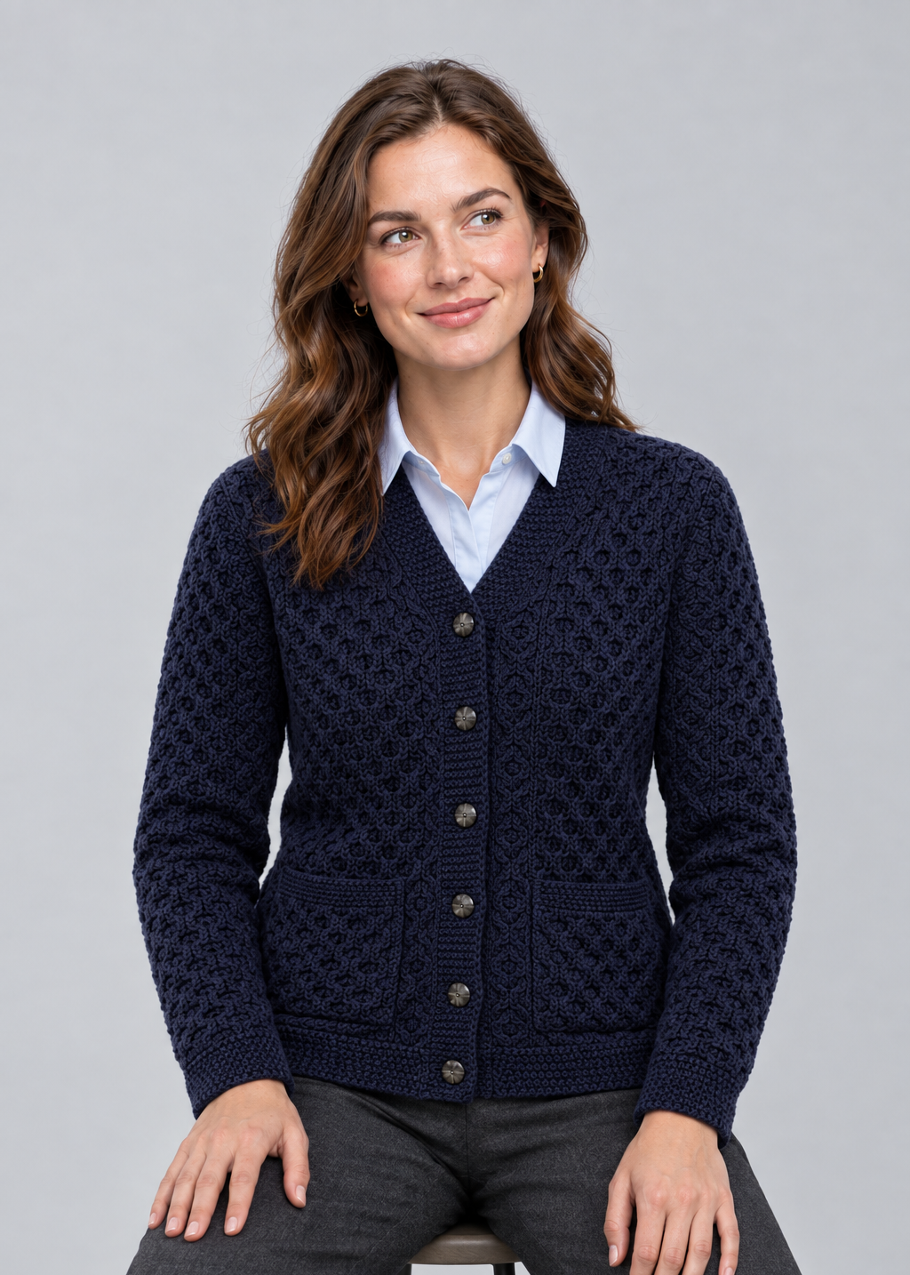 Navy cardigan, seated studio pose