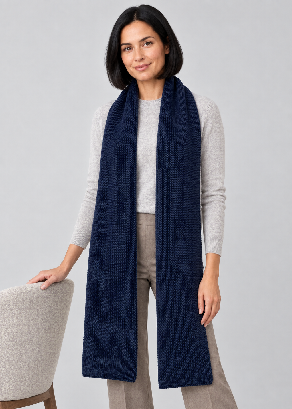 Navy scarf studio pose beside a chair