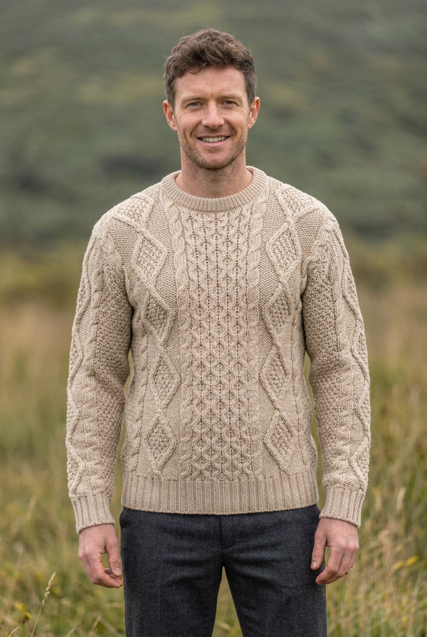 Oatmeal Aran sweater, lively front pose with the wine-red sweater’s model and grassland backdrop