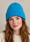Female model wearing the blue 100% Donegal wool turn-up beanie hat, head and shoulders shot
