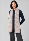 Scarf over navy Aran knitwear, angled pose