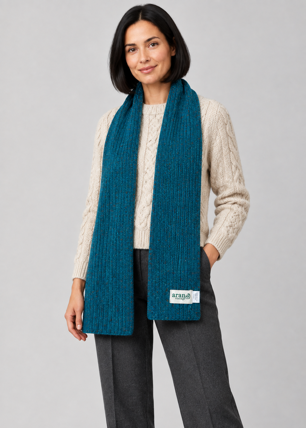 Teal scarf over Aran knitwear, standing pose
