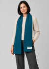 Teal scarf over Aran knitwear, standing pose