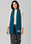 Teal scarf over Aran knitwear, stepping pose