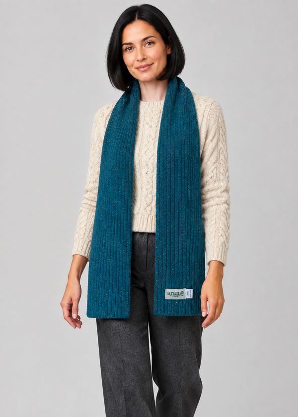 Teal scarf over Aran knitwear, stepping pose