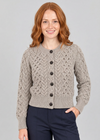 Three-quarter studio pose with hand in pocket