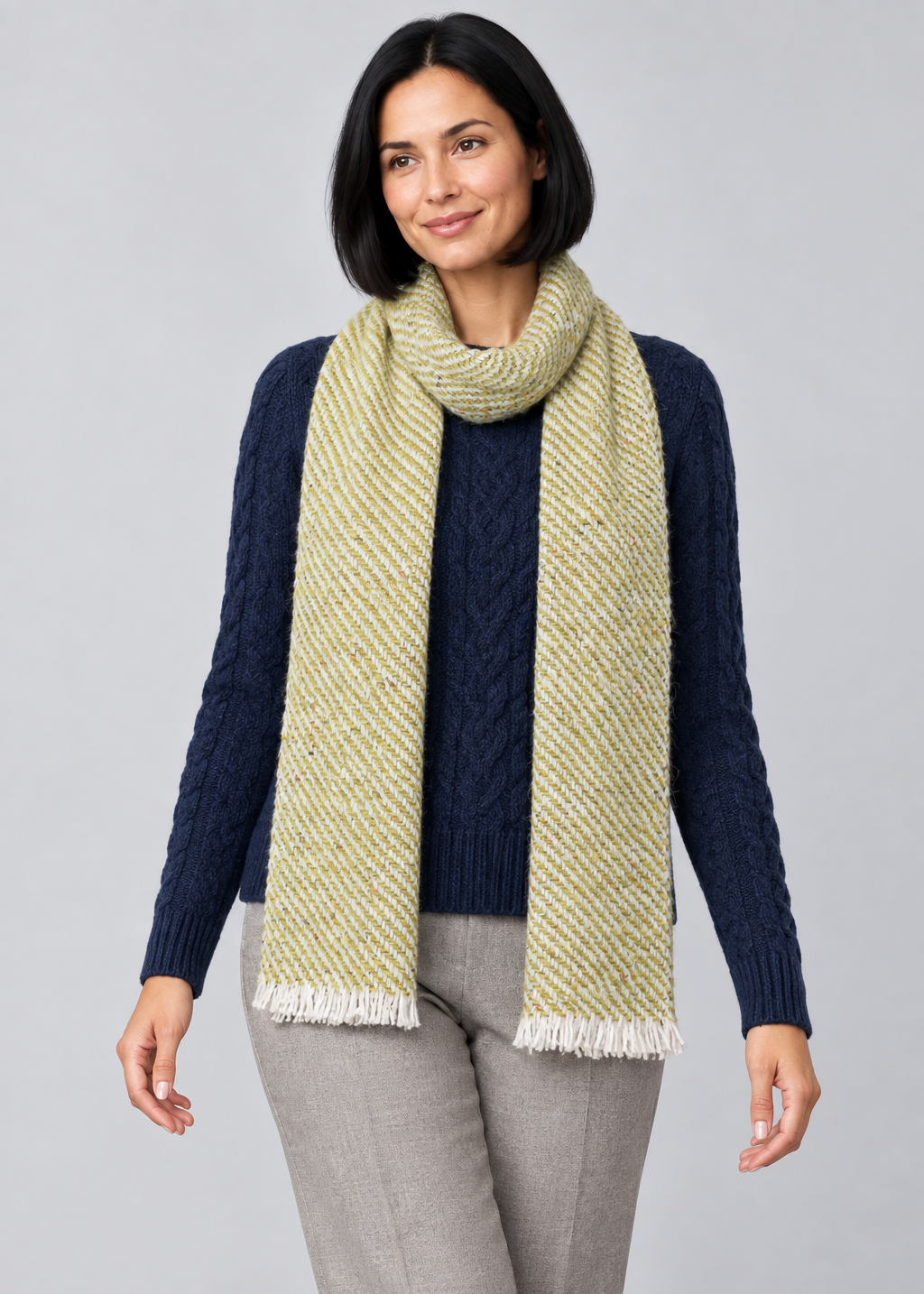 Woven scarf over Aran knitwear, stepping pose