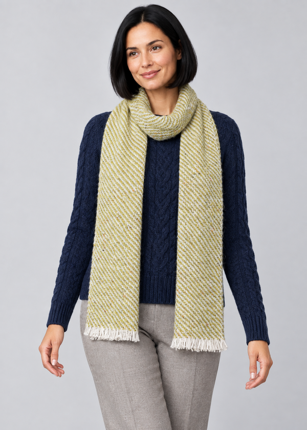 Woven scarf over Aran knitwear, stepping pose